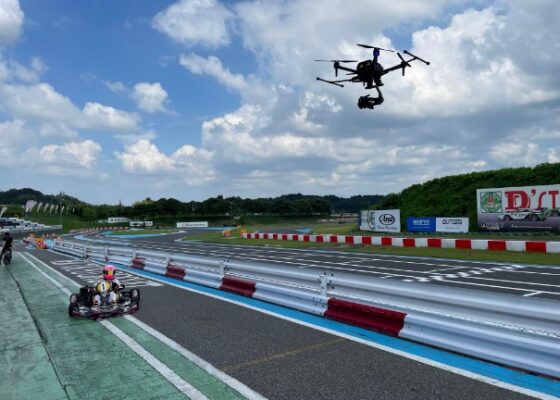 An Air-Peak drone is flying over the cart driver