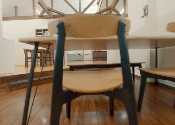 Microdrone is flying between a table and chair