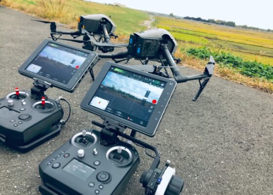 Two normal drone controllers and normal drones on the road